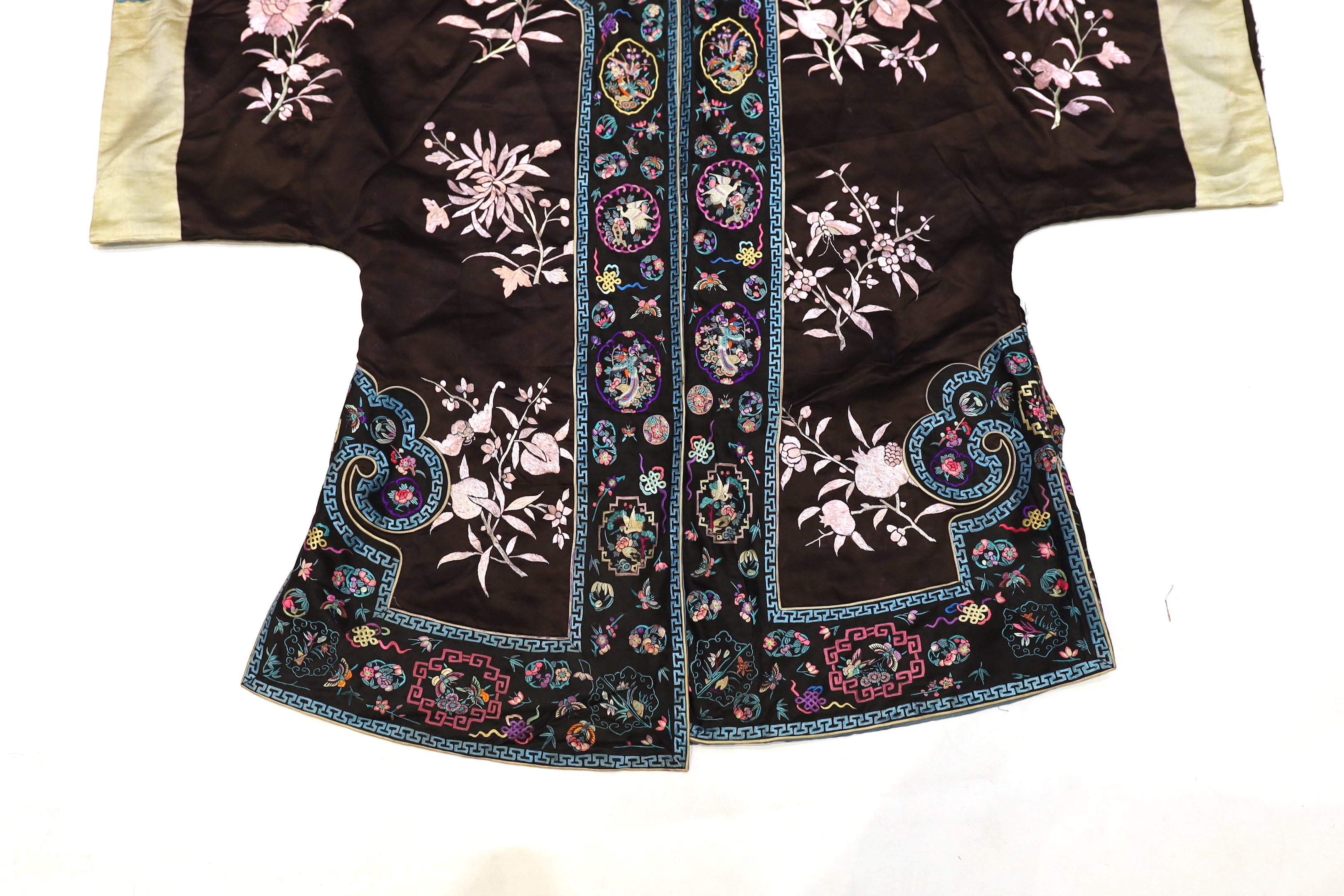 A Chinese early Republic blue silk embroidered robe with colourful ornately embroidered sleeve bands and borders to the robe